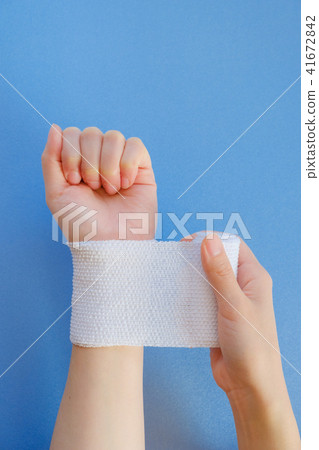 Hand wrapping a bandage 41672842