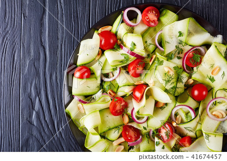 zucchini ribbon salad on a black plate zucchini ribbon salad on a black plate 41674457