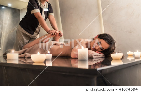 Young woman enjoying the stretching techniques of Thai massage 41674594