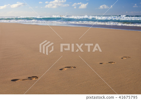Footprints in the sand on ocean beach. Footprints in the sand on ocean beach. 41675795
