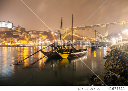 Boats on calm water in Porto at night 41675811