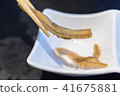 chopsticks holding fish bone senbei 41675881