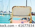 Conceptual Image Empty Vintage Chair at Sea Harbor 41677834