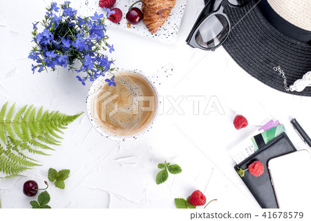 Women's accessories, lady on vacation. Sunglasses and hat, croissant and coffee for breakfast. 41678579