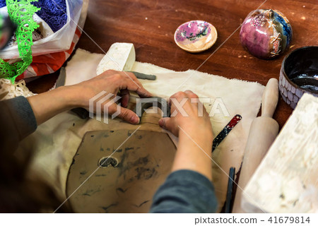 Pottery workshop. hands make print on clay 41679814