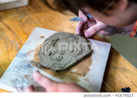 Pottery workshop. hands make print on clay 41679821