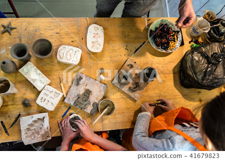 Pottery workshop. hands make print on clay 41679823