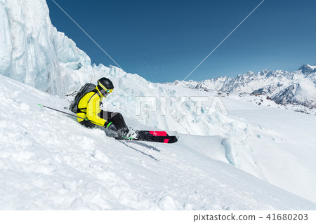 The total length of skiing on fresh snow powder. Professional skier outside the track on a sunny day 41680203