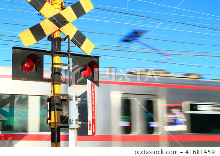 A train passing through a railroad crossing A train passing through a railroad crossing 41681459