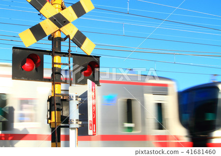 A train passing through a railroad crossing A train passing through a railroad crossing 41681460