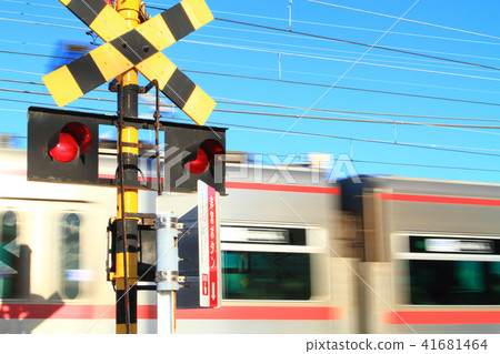A train passing through a railroad crossing A train passing through a railroad crossing 41681464