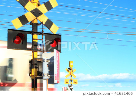 A train passing through a railroad crossing A train passing through a railroad crossing 41681466