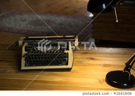An old typewriter and a lamp on a wooden lacquered 41681606