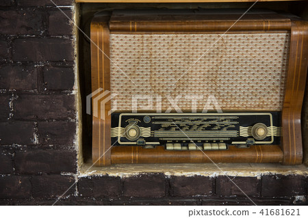 Old radio on a background of brown brick wall 41681621