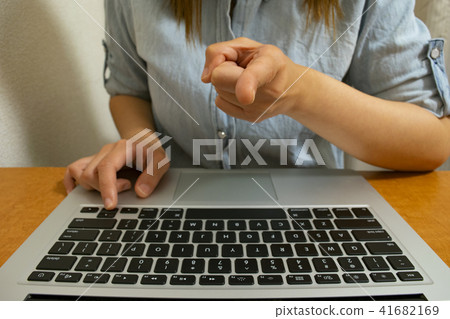 A woman pointing at a laptop computer finger 41682169