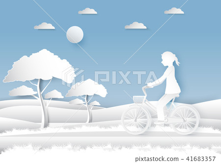 Girl riding a bicycle in the field on blue sky 41683357