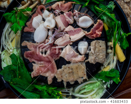 Cooking barbecue Thai style, called Moo Kra Ta 41683433