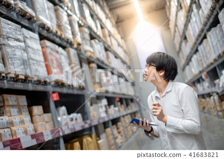 Asian man checking the shopping list in warehouse 41683821