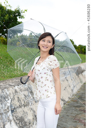 A woman holding an umbrella 41686280