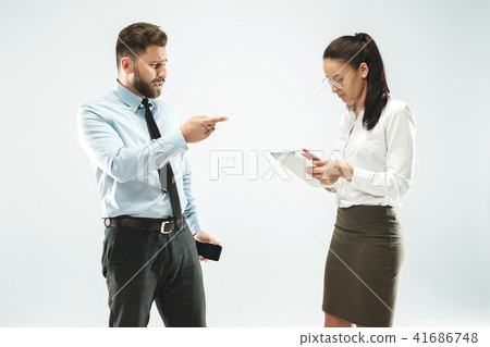 a business man shows the laptop to his colleague in the office. 41686748