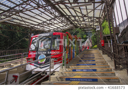 Mitakeyama Cable Car Red vehicle and staircase platform that stops at Takimoto Station 41688573