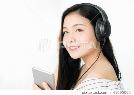 Asian Women are listening to music. Asian Women are listening to music. 41695093