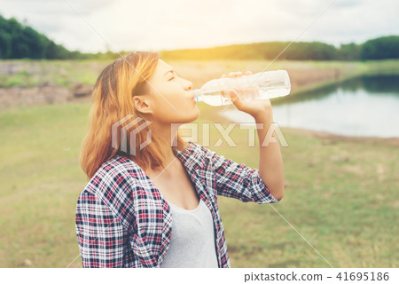young hipster woman drinking water at summer young hipster woman drinking water at summer 41695186