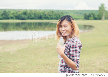 young hipster woman holding bottle of water  41695227