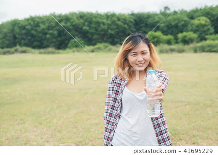young hipster woman holding bottle of water young hipster woman holding bottle of water 41695229