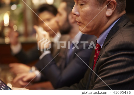 A businessman drinking at a bar A businessman drinking at a bar 41695486