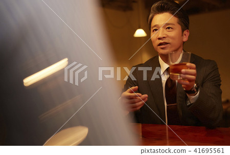 A businessman drinking at a bar A businessman drinking at a bar 41695561