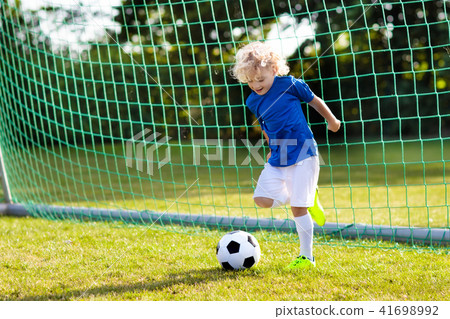 Kids play football. Child at soccer field. 41698992
