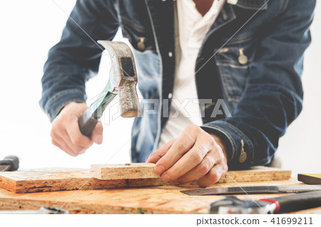 Carpenter working carefully looking at the plans work in carpent Carpenter working carefully looking at the plans work in carpent 41699211