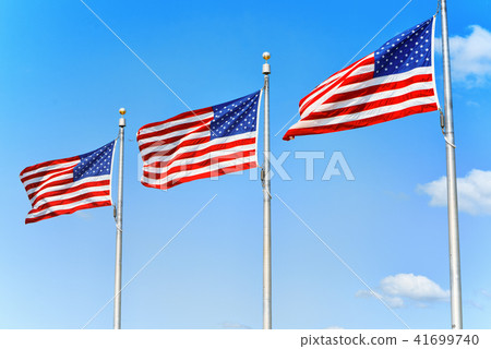 Star-striped American flags flutters proudly Star-striped American flags flutters proudly 41699740