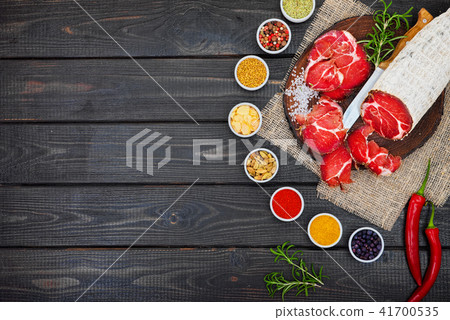 Sliced cured sausage, meat with spices. Sliced cured sausage, meat with spices. 41700535