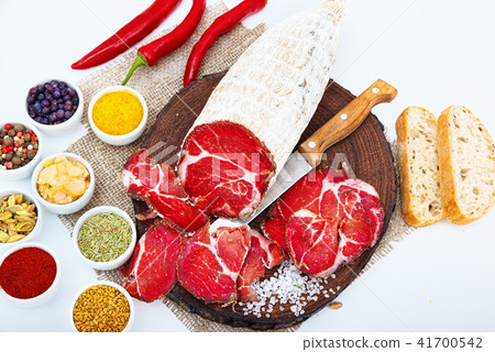 Sliced cured sausage, meat with spices. Sliced cured sausage, meat with spices. 41700542