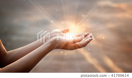 Human hands praying on sunset background 41700614