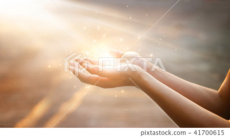 Woman hands praying on sunset background 41700615