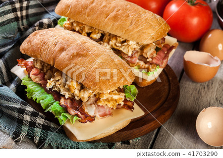 Ciabatta sandwich with smoked bacon and eggs Ciabatta sandwich with smoked bacon and eggs 41703290