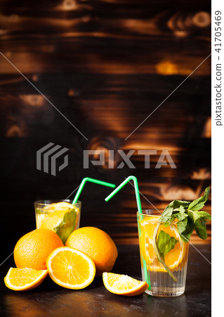Delicous healthy orangeade on wooden background Delicous healthy orangeade on wooden background 41705469
