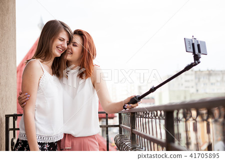 Happy and positive female friends taking a selfie Happy and positive female friends taking a selfie 41705895
