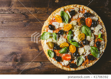 Traditional italian pizza on wooden table Traditional italian pizza on wooden table 41706392