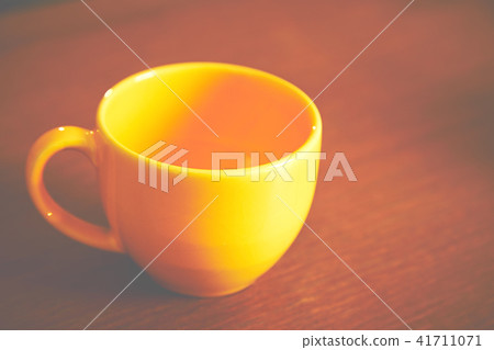 Empty yellow cup of coffee Empty yellow cup of coffee 41711071