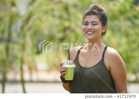 Woman enjoying tasty smoothie Woman enjoying tasty smoothie 41712970