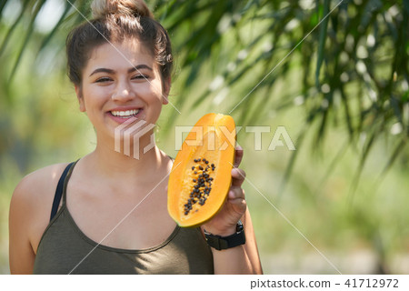 Woman with exotic fruit 41712972