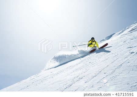 The total length of skiing on fresh snow powder. Professional skier outside the track on a sunny day The total length of skiing on fresh snow powder. Professional skier outside the track on a sunny day 41715591