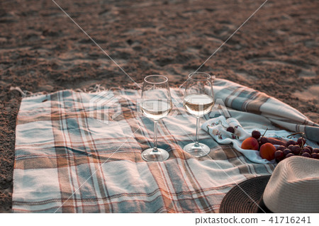 A party on the beach at sunset with wine. Romantic evening in the summer by the sea. Picnic. copy 41716241