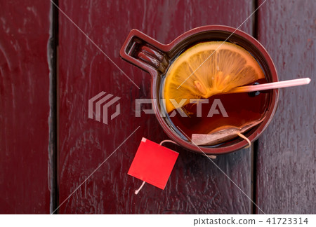 Plastic Cup with tea and lemon on wooden table 41723314