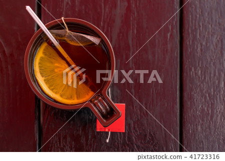 Plastic Cup with tea and lemon on wooden table 41723316