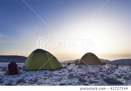 Backpacks and tents of tourists are located on top Backpacks and tents of tourists are located on top 41727244